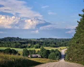 Idyllic countryside road with impressiove clouds above