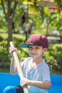 Portrait of boy wearing hat sitting outdoors