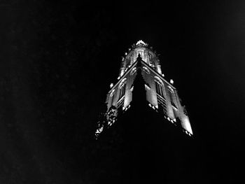 Low angle view of illuminated christmas tree against sky at night