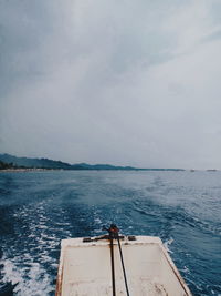 Sailboat sailing on sea against sky