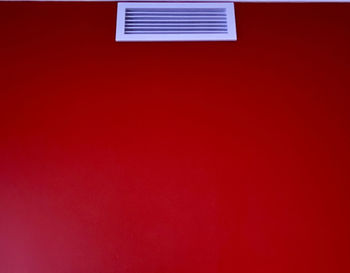 Low angle view of red wall