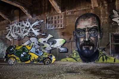 Portrait of man with graffiti on wall