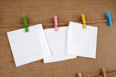 Close-up of paper hanging against white wall