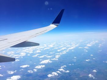 Cropped image of airplane flying over landscape