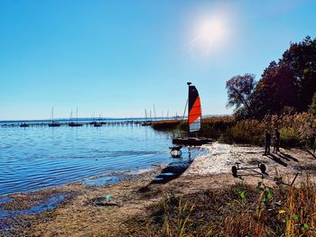 Scenic view of river against clear blue sky