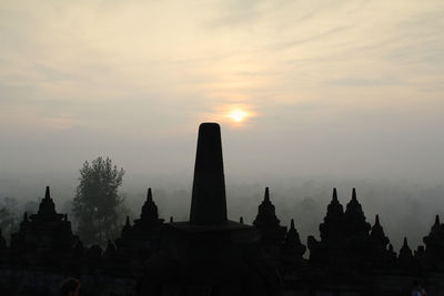 Silhouette temple against sky during sunset