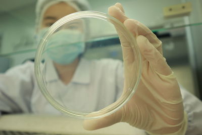 Close-up of man holding glass