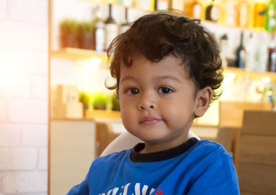 Close-up portrait of cute boy at home