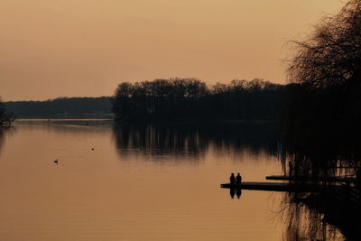 Scenic view of lake against sky during sunset