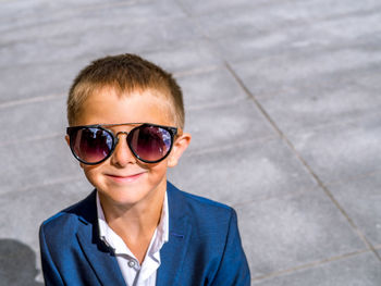 Portrait of smiling cute boy wearing sunglasses