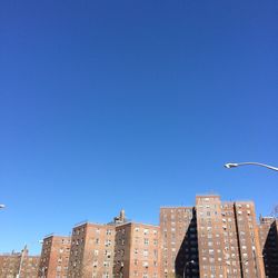 Low angle view of buildings against blue sky