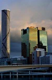 Low angle view of skyscraper against sky during sunset