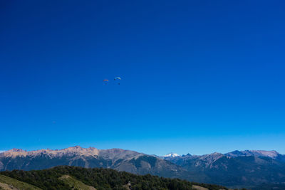 Scenic view of mountains against clear blue sky