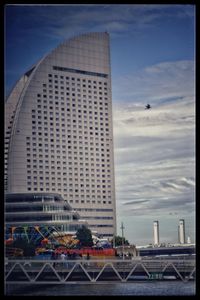 Modern buildings against cloudy sky