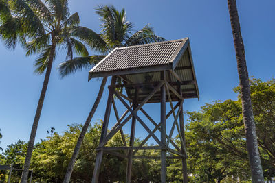 Low angle view of water tower against clear blue sky