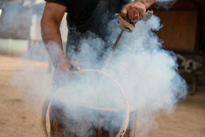 Midsection of man preparing food