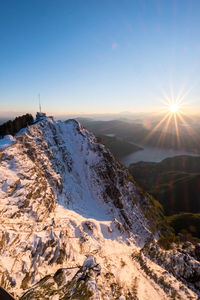 Scenic view of snow mountains against sky during sunset