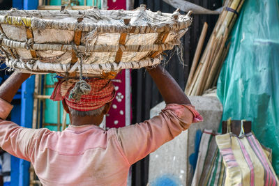 Rear view of man working at market stall