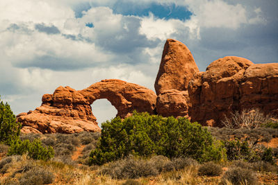 Rock formations on landscape against sky