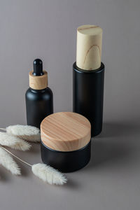 Facial and body care cosmetics bamboo bottles composition on brown background. beauty face oil