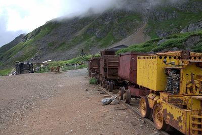 Abandoned train on land against sky