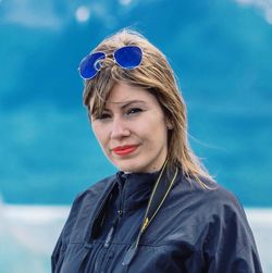 Portrait of woman wearing sunglasses against sky