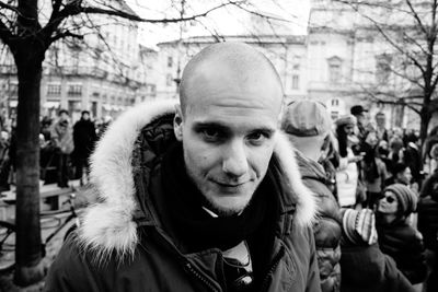 Portrait of man standing on crowded street