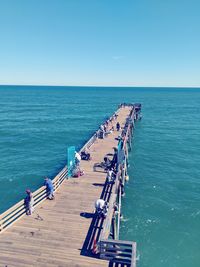 High angle view of pier over sea against clear sky