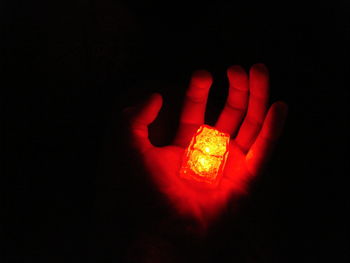 Close-up of red light over black background