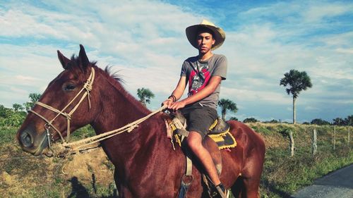 Portrait of young man riding horse