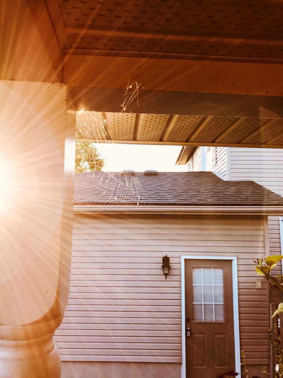 LOW ANGLE VIEW OF SUNLIGHT STREAMING THROUGH WINDOW ON BUILDING