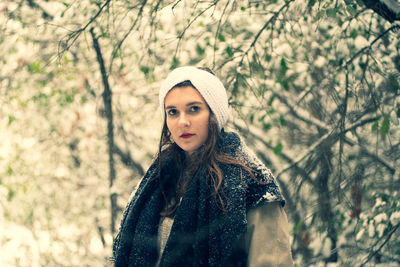 Portrait of young woman in winter forest