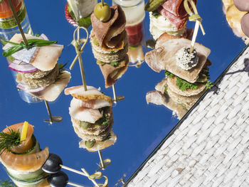 High angle view of various canapes and snacks served on table