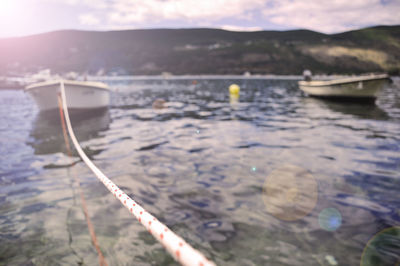 Close-up of boat in river against sky