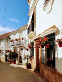 Street amidst buildings in city against sky