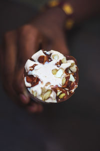 Close-up of hand holding ice cream