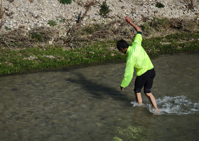 Rear view of woman standing in water