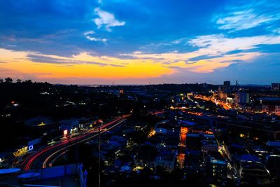 High angle view of illuminated city against sky during sunset