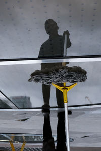 Reflection of man on glass window