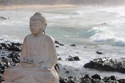 Statue of buddha on beach brazil vibe 