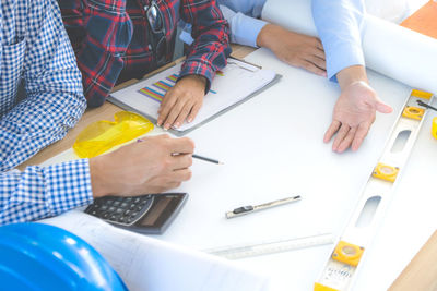 High angle view of people working on table