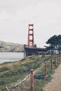 Golden gate bridge over sea against sky