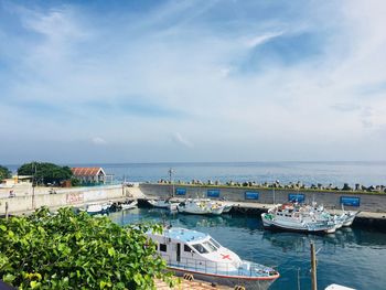 High angle view of marina and sea against sky