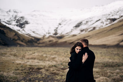 Young couple standing on land