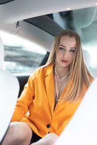 Portrait of young woman in car