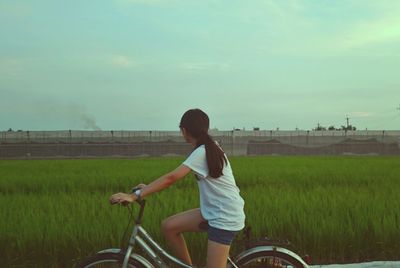 Woman bicycling on landscape