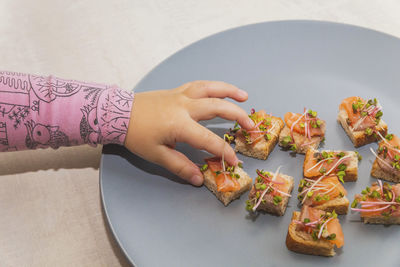 Cropped hand of person preparing food