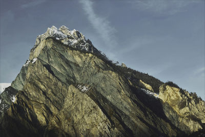 Low angle view of rock formation against sky