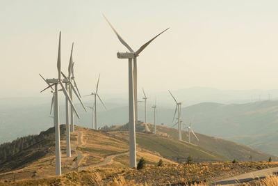 Windmill on field against sky