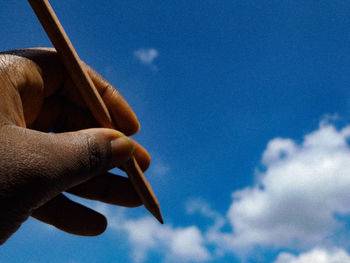 Low angle view of cropped blue sky